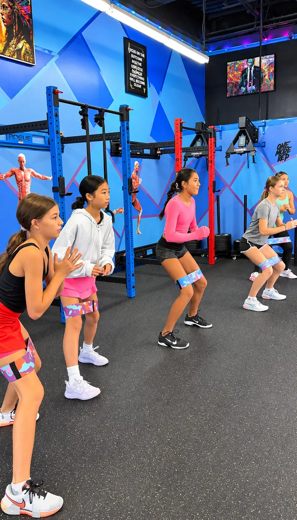 Young tennis athletes practicing resistance-band strength and balance exercises at Stretch Plus Flex in Great Neck, NY
