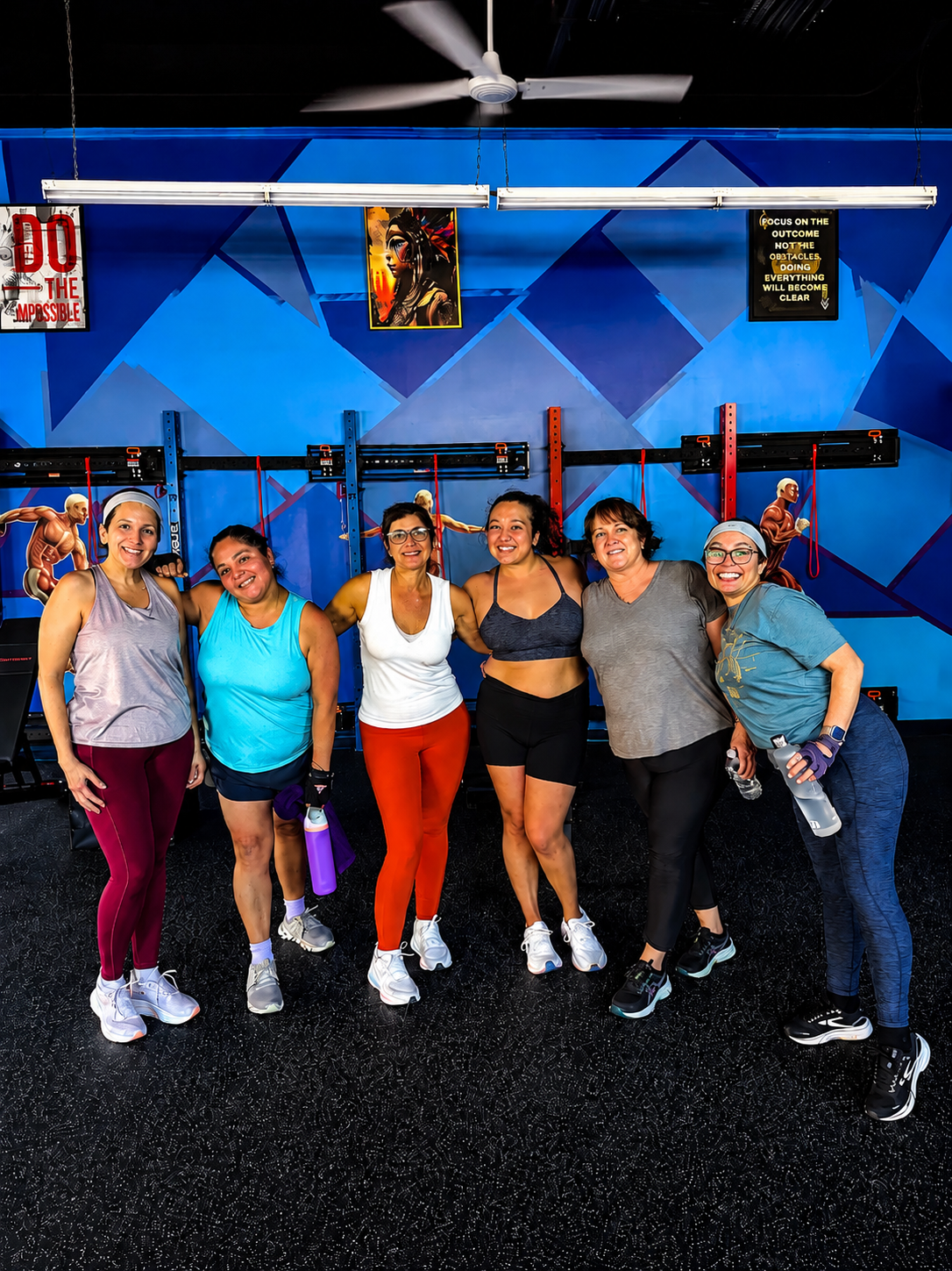 A supportive group of women smiling together after a small-group training class at StretchPlusFlex in Great Neck