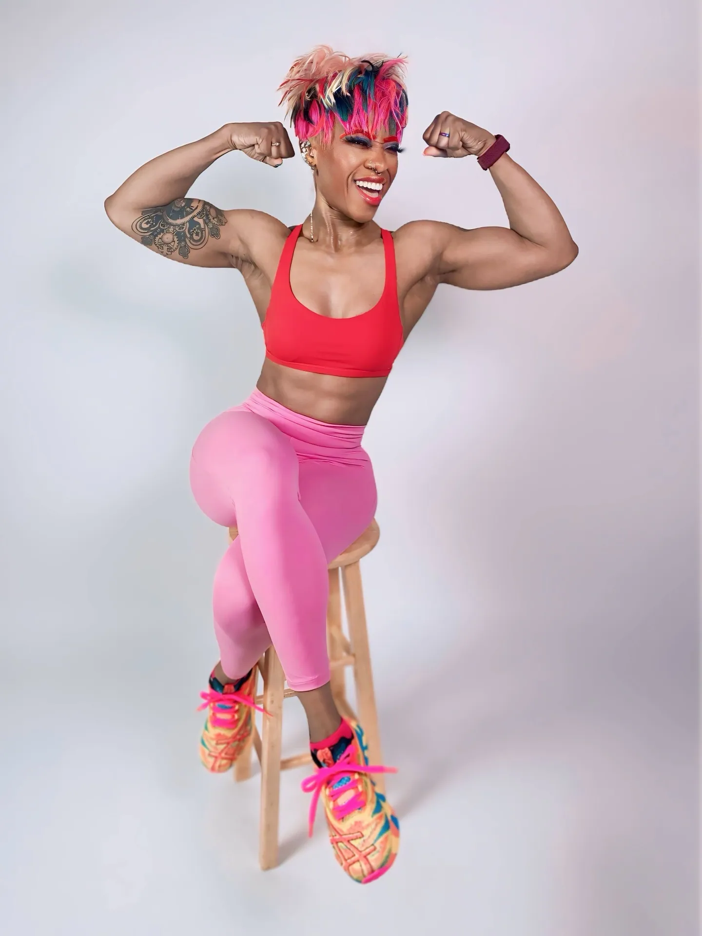 Coach Roxy flexing her biceps during a strength training session